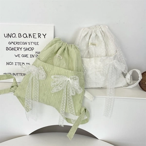 Detailed close-up of lace flower drawstring backpack with large mesh ribbon bow decoration