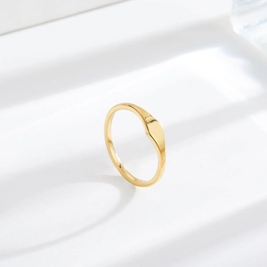 Minimalist gold-plated stainless steel signet ring with a polished flat mirror surface