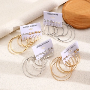 Detailed set of fashion earrings featuring gold and silver hoops with pearl and rhinestone accents