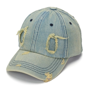Close-up of light blue washed denim baseball cap with distressed ripped holes details