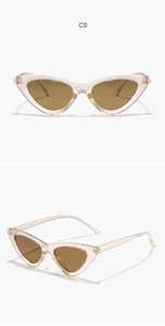 Detail view of pink cat-eye sunglasses with brown lenses and a vintage oversized frame