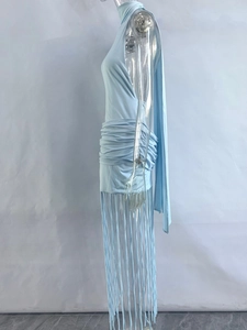 Close-up of light blue halter dress featuring pleated waist and long fringe hem details
