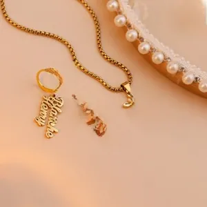 Detail of custom engraved gold stainless steel necklace and earrings set with name Blanche Henry