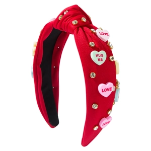 Red knot headband with rhinestone heart candy charms and LOVE lettering on white background