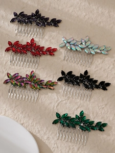 Detail view of multi-color crystal leaf hair combs with marquise-cut stones and silver base