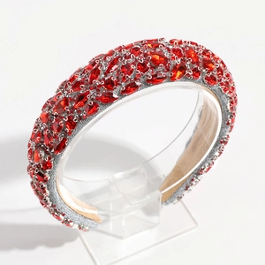 Detailed view of red crystal wide headband with sparkling faceted gems and silver finish
