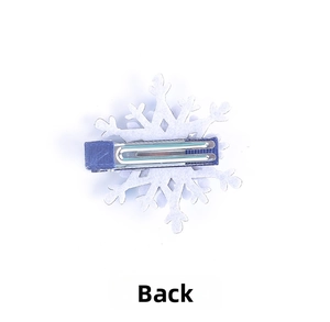 Detail view of the back of a snowflake hair clip with blue ribbon wrapped metal clip