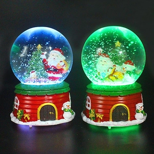 Luminous Christmas crystal ball with Santa and snowman figurines in glowing red base