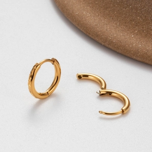 Engraved and polished gold stainless steel hoop earrings with hinged closure detail