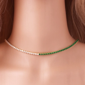 Elegant gold tennis necklace with green and white round-cut zircons on female neck