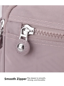 Close-up of durable metal zipper with brand logo on purple waterproof nylon crossbody bag