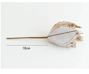 Macro detail of 18cm cream fabric Christmas leaf with elegant gold glitter edges