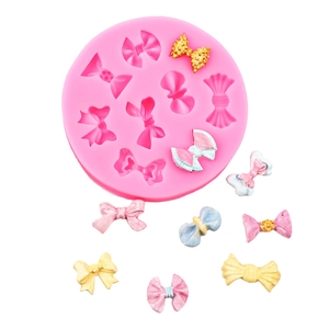 Detail of pink silicone mold for DIY fondant bows with various 3D bow shapes and sizes