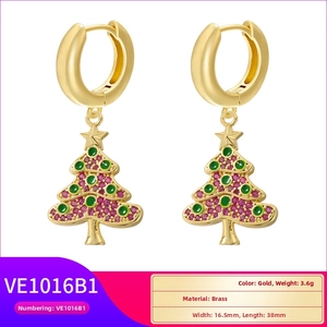 Detail view of brass Christmas tree earrings with gold plating and star charms
