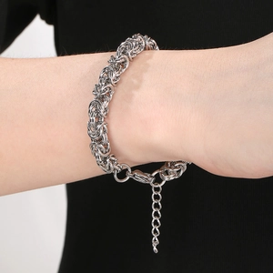 Silver woven dragon bone titanium steel bracelet for men and women on model wrist