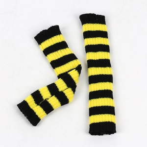 Detail of knitted arm warmers with black and yellow stripes on a white background
