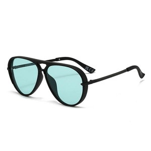 Detail view of matte black aviator sunglasses frame with blue-green tinted lenses