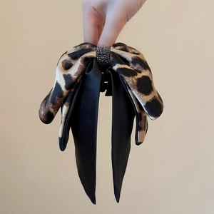 Leopard print bow claw clip with black satin ribbons and sparkling rhinestone center
