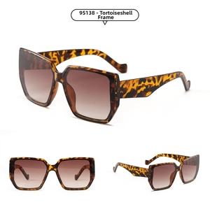 Detail view of tortoiseshell oversized square sunglasses with brown gradient lenses