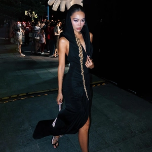 Detail view of backless black hooded evening dress with high side slit and slim fit