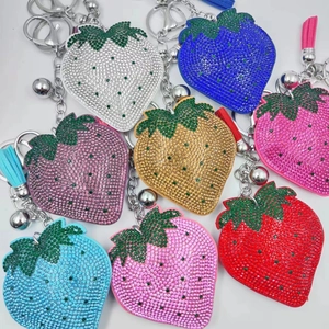 Detail of strawberry keychains with rhinestones and tassels in multiple colors
