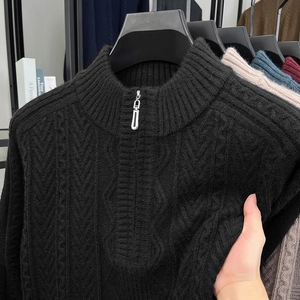 Detail shot of black cable knit sweater showing soft texture and half-zip collar