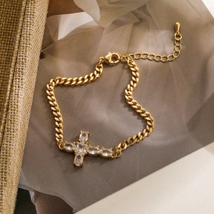 Detail view of gold-plated Cuban link bracelet with zircon cross pendant and lobster clasp