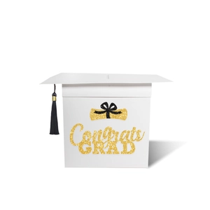 Close-up of white graduation card box shaped like a mortarboard with black tassel and gold text