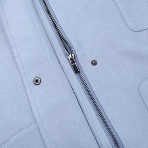 Detailed view of light blue suede jacket with silver zipper and metallic snap buttons