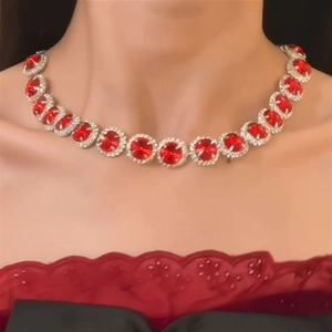 Elegant silver necklace with red circular gemstone set on model neck for luxury jewelry set