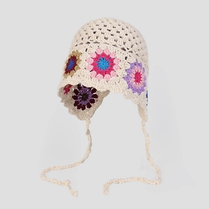 Handmade crochet boho beanie with colorful floral patterns and vintage straps