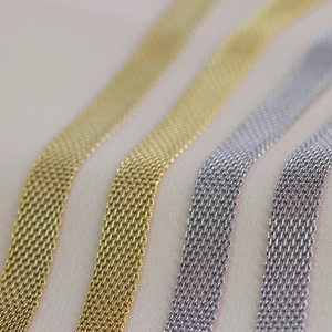 Macro view of woven metal mesh texture on 8mm wide choker necklaces in gold and silver