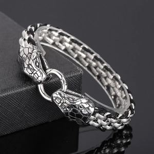 Detail of silver double snake head stainless steel woven chain bracelet with round clasp