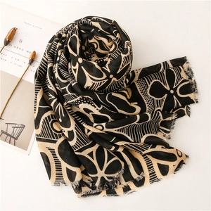 Detail view of cotton-linen scarf with geometric floral pattern and frayed edge fringe