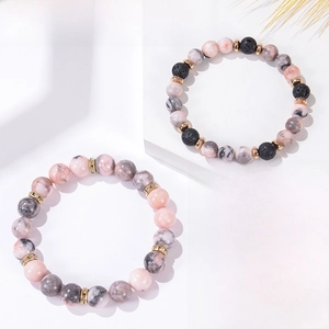 Detail of 8mm pink zebra jasper and lava stone healing yoga bracelet with metal accents