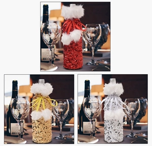 Detailed view of sequin wine bottle covers in red, gold, and silver with plush trim and ribbons