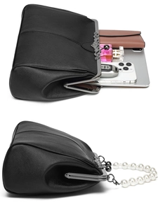 Detail view of black leather handbag capacity with metal clasp and pearl chain handle