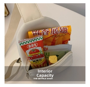 Macro shot showing the interior capacity of the white nylon chest bag with snacks