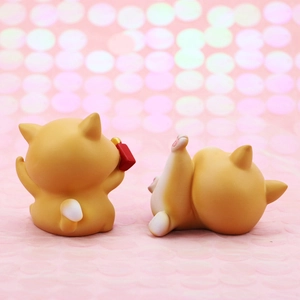 Rear view detail of two cute Shiba Inu resin dog figurines for car dashboard and desk