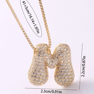 Detail of gold M-letter pendant with cubic zirconia and exact product dimensions