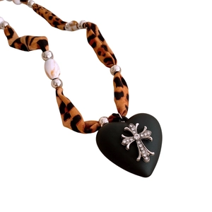 Leopard print fabric necklace with black heart pendant and rhinestone cross charm
