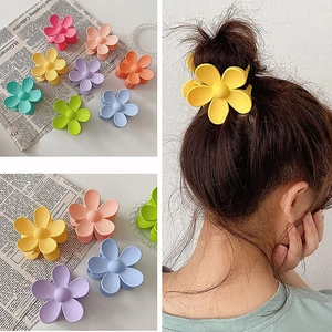 Daisy flower hair claws in colorful matte finishes shown on model and flat lay