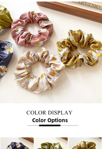 Daisy pattern scrunchies collection in various pastel colors like pink and olive green