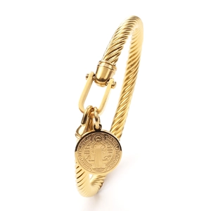Gold twisted stainless steel bracelet featuring a St. Benedict medal and U-shaped shackle clasp