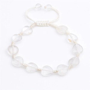 Detail of hand-woven white cord bracelet featuring heart-shaped crystal beads