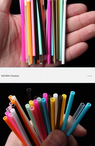 Close-up of colorful disposable hollow-stem lip brushes and eyelash wand handles