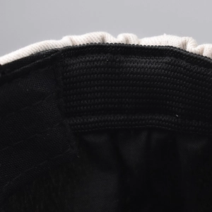 Detailed close-up of the knitted beret hat showing internal lining and elastic band