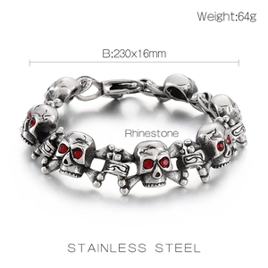 Macro detail of gothic skull bracelet featuring red rhinestone eyes and steel bones