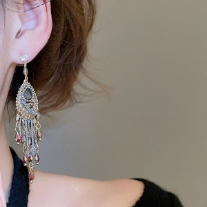 Macro view of vintage bohemian tassel earrings with sparkling crystals and gold chains