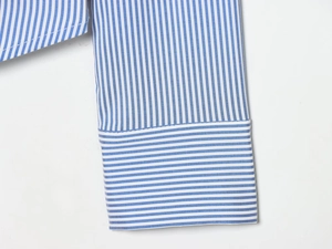 Detail of blue and white striped shirt cuff with vertical and horizontal pattern texture